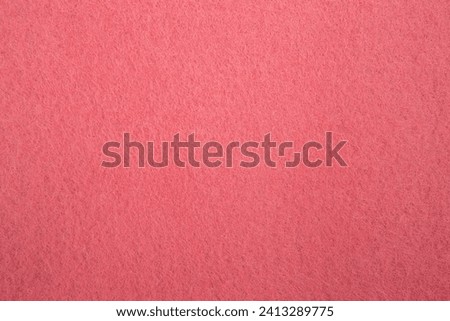 Felt fabric texture with visible fiber, peach pink color abstract pattern backdrop, close up