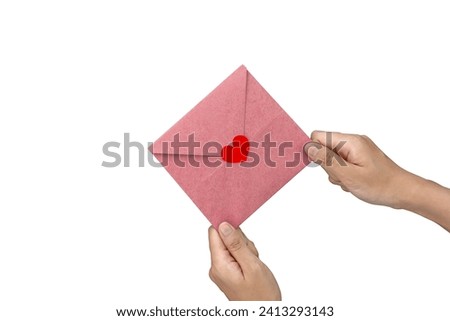 Close-up of woman's hand giving pink greeting card with red heart emoji. Sent on important days or birthdays, expressing love through letters. Symbols of Valentine's Day on a white background.