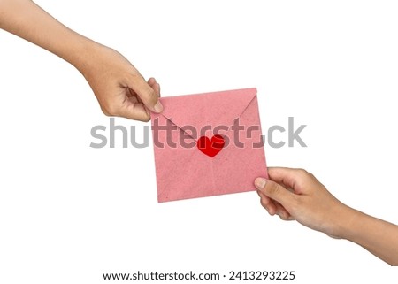 Close-up of woman's hand giving pink greeting card with red heart emoji. Sent on important days or birthdays, expressing love through letters. Symbols of Valentine's Day on a white background.