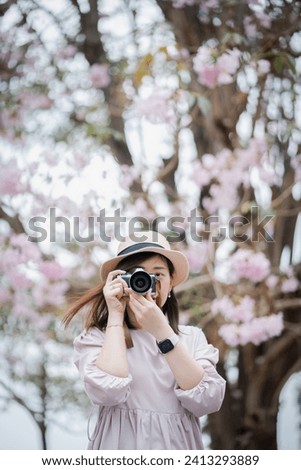 In springtime an asian woman photographer captures the moment