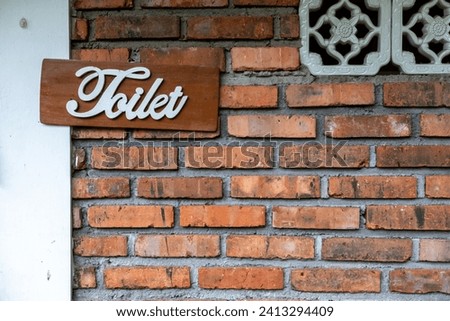 public toilet direction marker, traditional feel with exposed brick