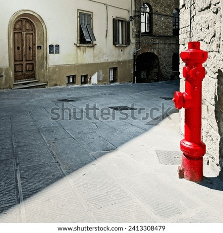 Fire Hydrant on the Street with Old Buildings in Italian City, Vintage Style Toned Picture