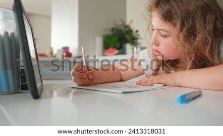 Cute Caucasian Girl Primary School Student Doing Homework using Tablet