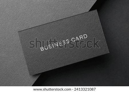 Business card on black background, top view