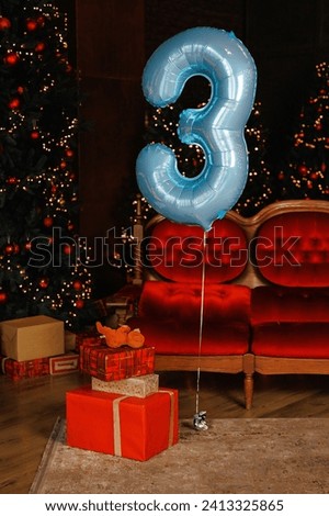 number 3 birthday ballon on red background.Chrismats holidays..Many birthday presents.Happy childhood boy or girl