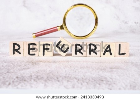 referral a word written on wooden cubes Royalty-Free Stock Photo #2413330493