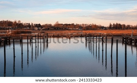 Almost empty marina with a kayak rower passing. Shot from Norsminde near Aarhus, Denmark Royalty-Free Stock Photo #2413333423