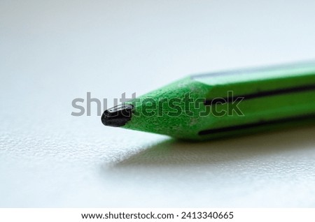 Macro shot of the sharpened lead pencil on white background.
