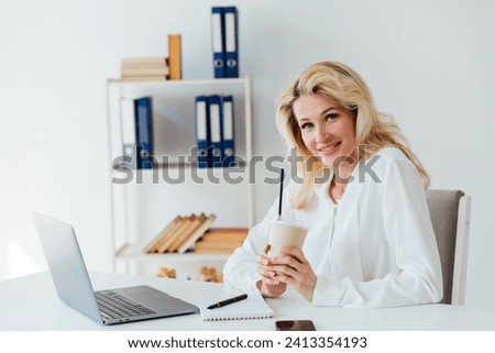 Woman rejoicing at work at computer office