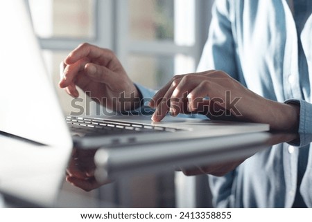 Close up, woman hand typing on laptop computer, surfing the internet on office table, online working. Student studying online class via laptop, e-learning, internet network, remote work
