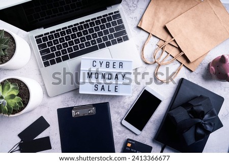 Cyber Monday shopping sale concept. Cyber monday sale text on lightbox, top view of offcice workspace ready for seasonal sales