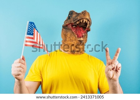 Image of a person in a dinosaur mask with an American flag and peace gesture.