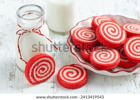 red and white pinwheel sugar cookies, white wooden background