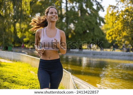 Woman running in the park. Female running in the city. Running woman. Female runner jogging during outdoor workout. Beautiful fit mixed race Fitness model outdoors.