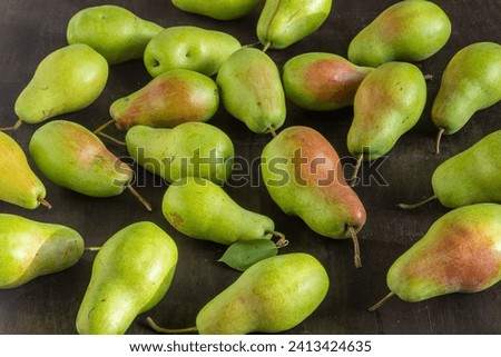 Parisian pear variety. Fruits on the table. Autumn harvest. Pears top view background. Green yellow red color pear. Vitamin vegan food.