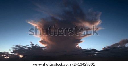 Tropical storm. Beautiful sunset sky with clouds. Sky blue and orange light of the sun through the clouds in sky. Background of dark clouds before storm. Dramatic clouds. Apocalyptic sky, dark cloud.