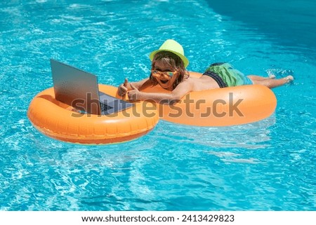 Outdoor summer business. Child working on laptop computer at poolside swimming pool. Summer online technology. Traveler relaxing on tropical sea beach in summer holidays vacation. Summer travelling.