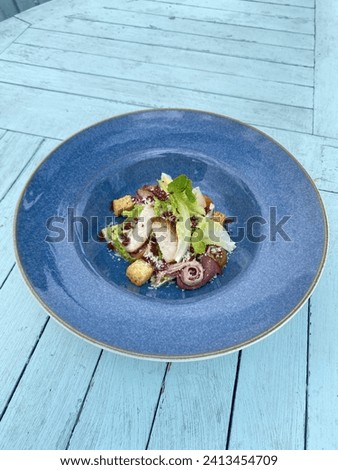A picture of an appetiser made from lettuce, sliced chicken breast, garlic bread, premade cheese and beef bacon