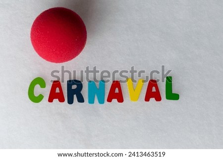 colored letters with the word carnival and a clown nose on a white background and space to work

