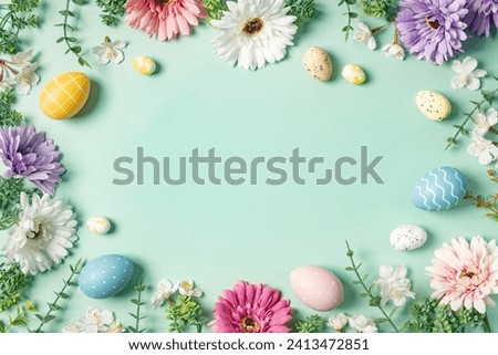 Happy Easter composition for easter design. Elegant Easter eggs and spring flowers on mint background. Flat lay, top view, copy space. Royalty-Free Stock Photo #2413472851