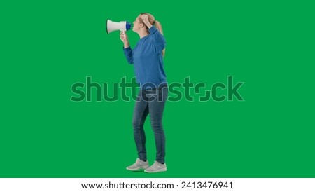 Female activist with raised fist speaking menacingly into megaphone in studio on green screen. Protest action, fight for women's rights, strike. Advertising, promo, chroma key.