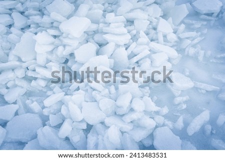 Ice hummocks background texture. Broken ice shards lay on frozen Baltic Sea surface on a winter day, top view
