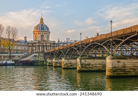 Peaceful Seine river and Old Town of Paris (France) in the calm beautiful sunrise of the autumn. Famous L'Hôtel national des Invalides (The National Residence of the Invalids) in the background. 