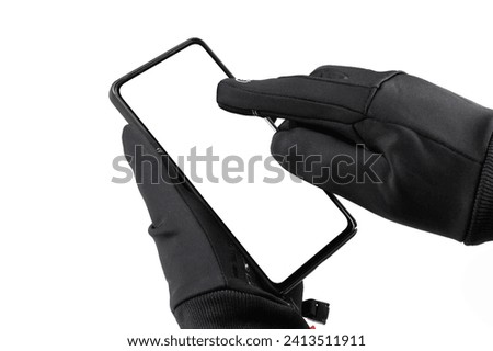 black thermal gloves and smartphone isolated on white background. Sport accessories for ski and snowboarding.
