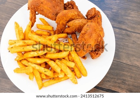 Fried whole chicken wings on white plate  Royalty-Free Stock Photo #2413512675