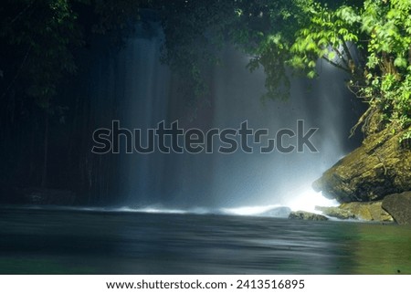 The waterfall flows fast and is very cool and cool when you are near it Royalty-Free Stock Photo #2413516895