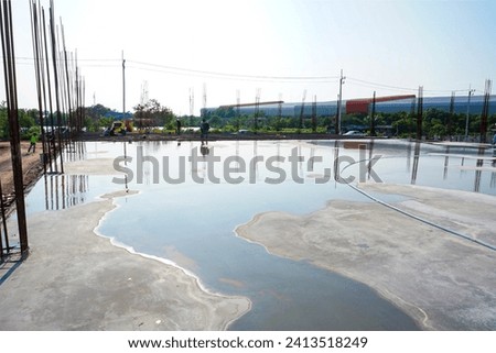 Construction Process : Concrete curing by water Royalty-Free Stock Photo #2413518249