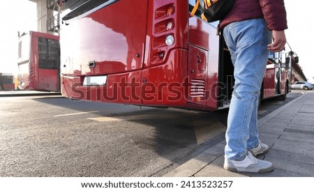Commuter waiting for a bus at city station. Royalty-Free Stock Photo #2413523257
