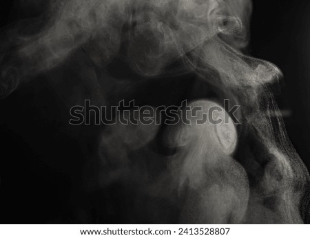 The movement of steam. Smoke. Blur. Abstract. Black background. Copy space.