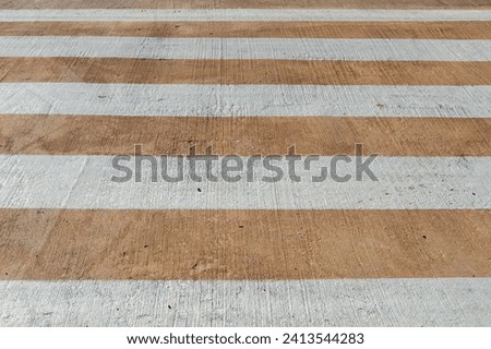 background with pedestrian crossing with white and brown stripes