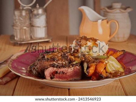 Sliced venison with mashed potatoes roasted vegetables and a rick onion and mushroom gravy. Royalty-Free Stock Photo #2413546923