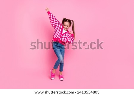Full size photo of good mood schoolgirl with tails dressed knit cardigan hand up dancing having fun isolated on pink color background