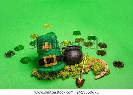 Gold coins scattered on green isolated background, St. Patricks hat, leprechaun kettle, shovel, horseshoe for good luck. Greeting card for traditional Irish holiday. Copy space, mock up