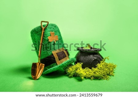 On green isolated background St. Patricks hat, leprechaun kettle with gold coins, shovel, horseshoe for good luck. Greeting card for traditional Irish holiday. Copy space, mock up
