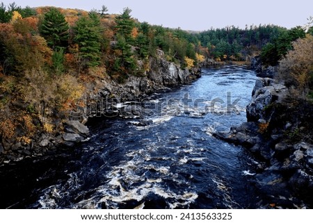 Beautiful fall scene of the St. Croix River  flowing through Interstate Park on a cold October day in Taylors Falls, Minnesota USA.