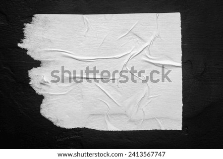 White torn poster with folds. Royalty-Free Stock Photo #2413567747