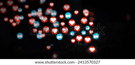 Sending or receiving likes and hearts on social networks, a person publishes news, the symbols of hearts and likes are added over image. Royalty-Free Stock Photo #2413570327