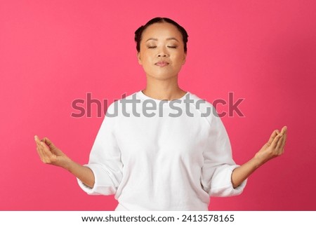 Zen. Peaceful Young Asian Woman Meditating With Closed Eyes, Calm Relaxed Korean Female Practicing Yoga, Keeping Hands In Mudra Gesture, Standing Isolated Over Pink Background, Copy Space
