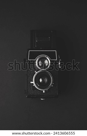 An old medium format camera on a black background