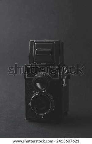 A vintage twin-lens camera on a black background