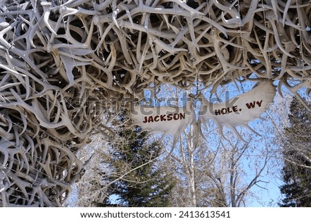 Antlers Arch with sign welcoming people to Jackson Hole, Wyoming, United States Royalty-Free Stock Photo #2413613541