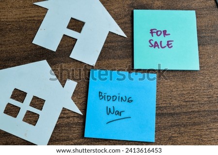 Concept of Bidding War and For Sale write on sticky notes isolated on Wooden Table.