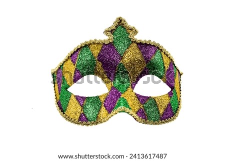 Gold, purple and green glittery Mardi gras mask isolated on white background Royalty-Free Stock Photo #2413617487