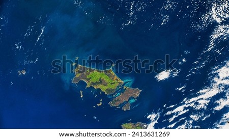 Flying Over Furneaux. The island chain was once part of a land bridge connecting Tasmania to mainland Australia. Elements of this image furnished by NASA. Royalty-Free Stock Photo #2413631269