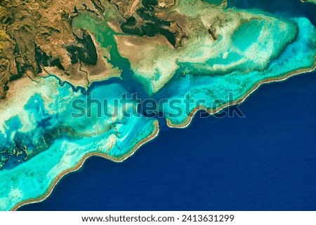 Reefs of New Caledonia. Home to an estimated 9,300 marine species and almost 500 species of coral, the reefs and lagoons are part of the UNESCO. Elements of this image furnished by NASA.