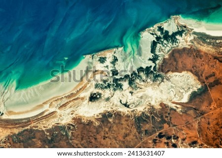 Mangroves on Eighty Mile Beach. Trees along this stretch of western Australia have an elongated root system that allows them to withstand high. Elements of this image furnished by NASA. Royalty-Free Stock Photo #2413631407